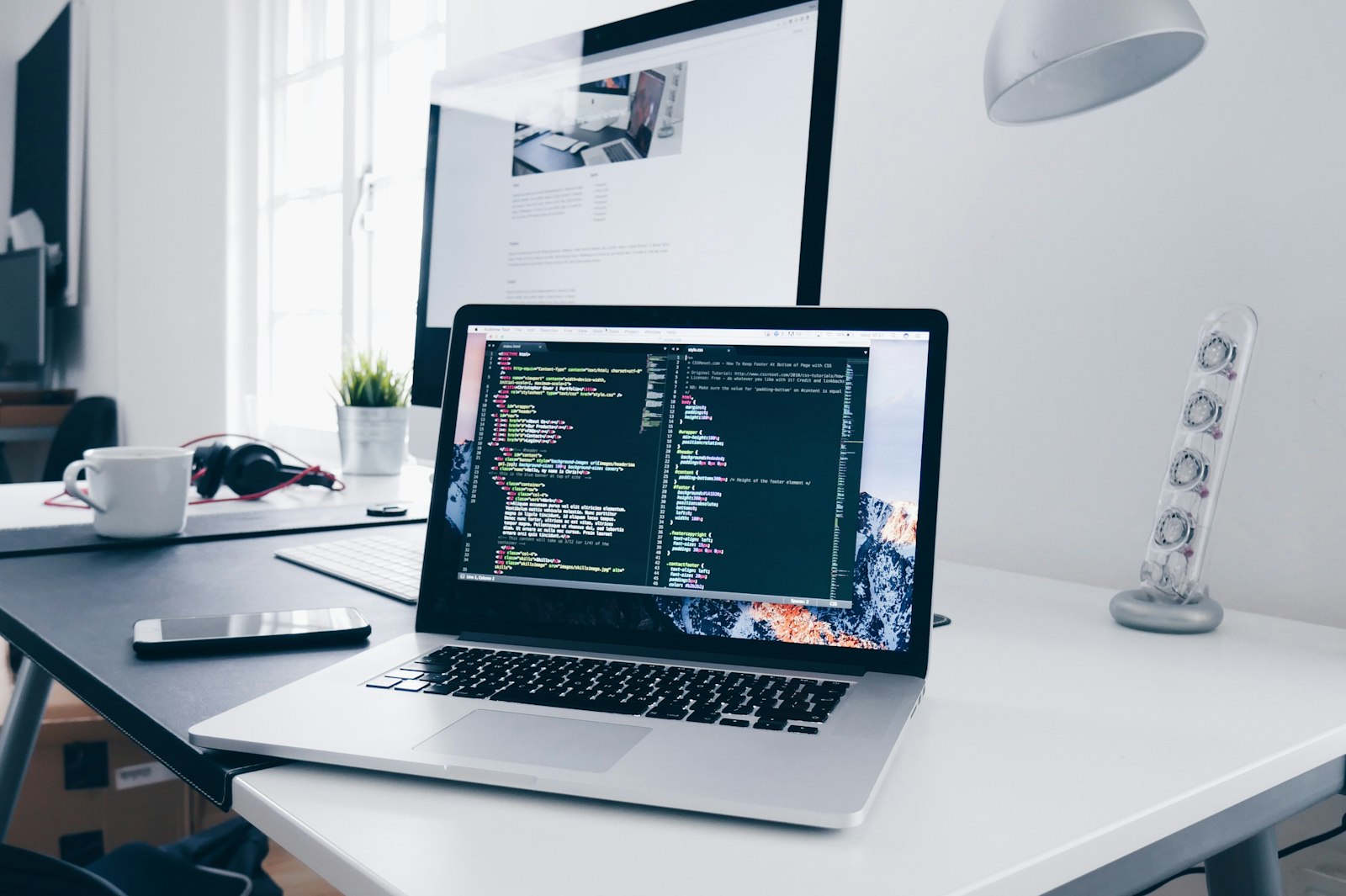 Laptop showing website code during a technical SEO audit