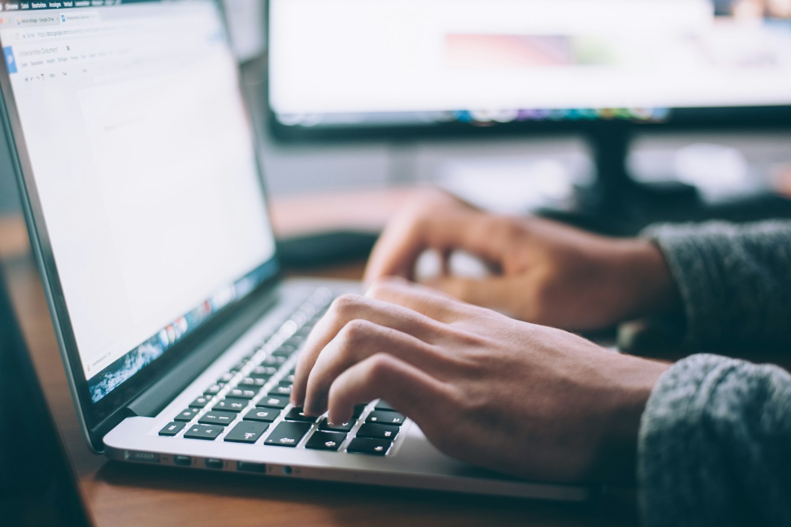 Blog Writing & Management at Rankvella — writer drafting content on a laptop