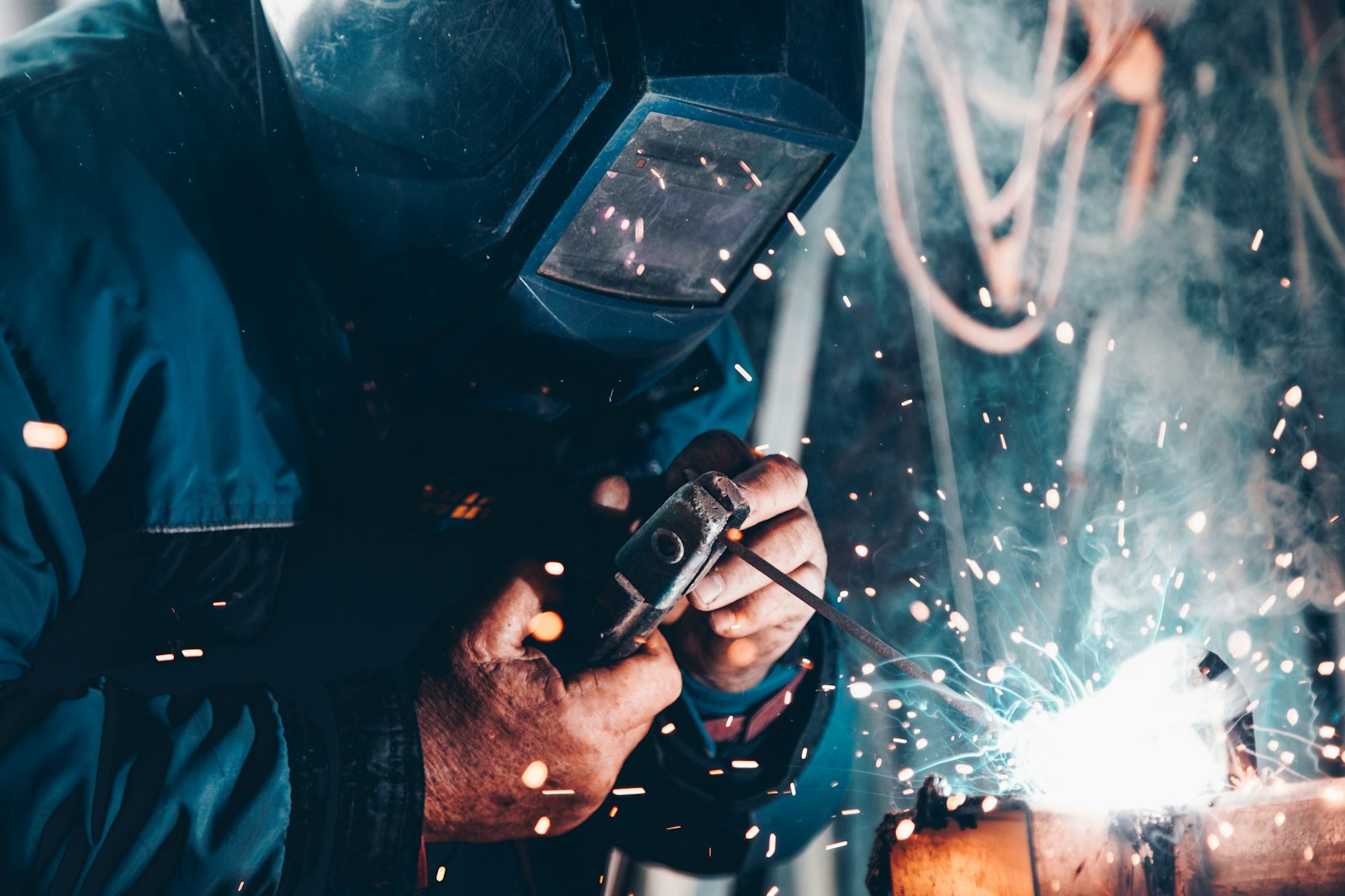 Manufacturing engineer welding in an industrial facility