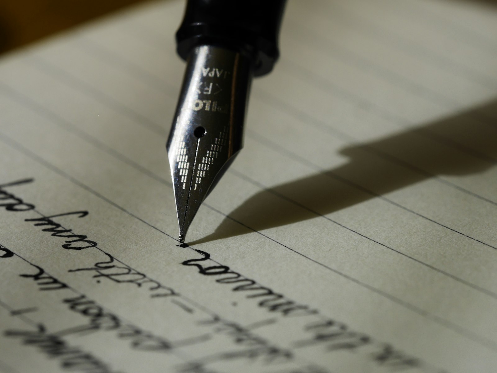 Fountain pen editing written notes, representing content revision